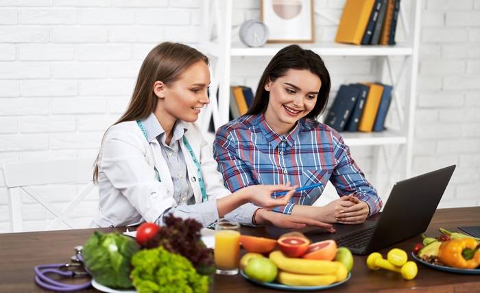 Why Nutrition Courses Matter in Modern Health smiling nutritionist advises young patient woman proper nutrition dieting